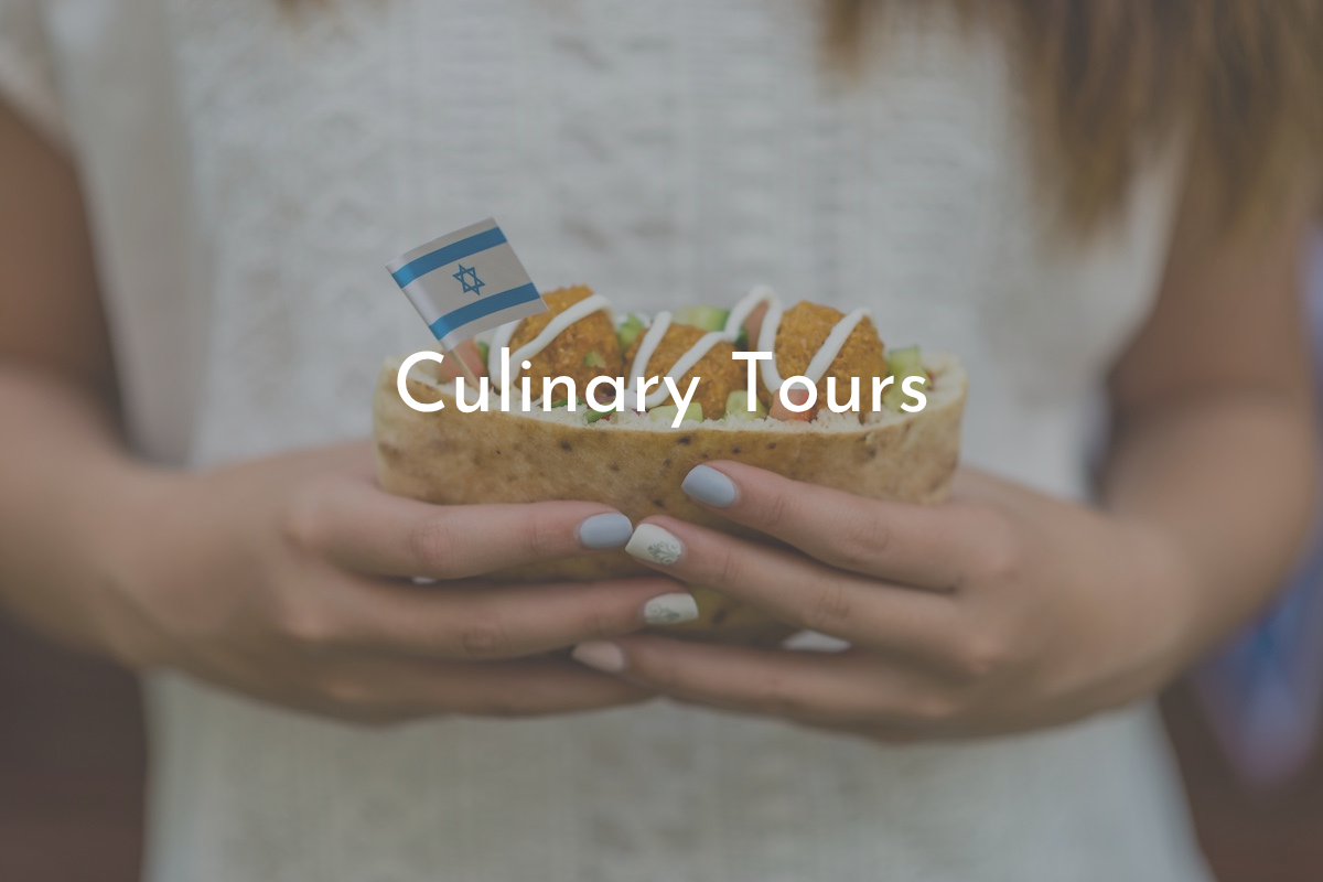 Pita street food in Israel held by a traveler, Israeli flag toothpick and title - culinary tours